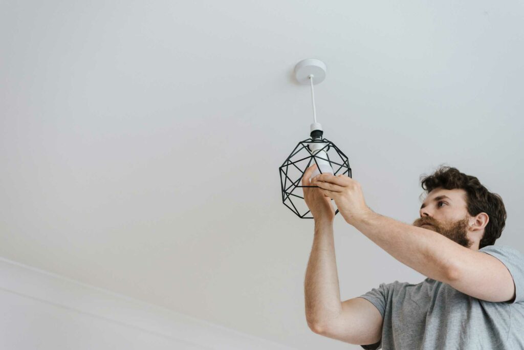 Handyman Homes Electrician putting in light bulb