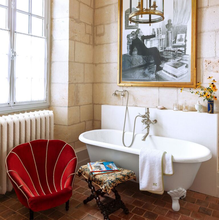 Bathroom design ideas artwork on wall and red chair